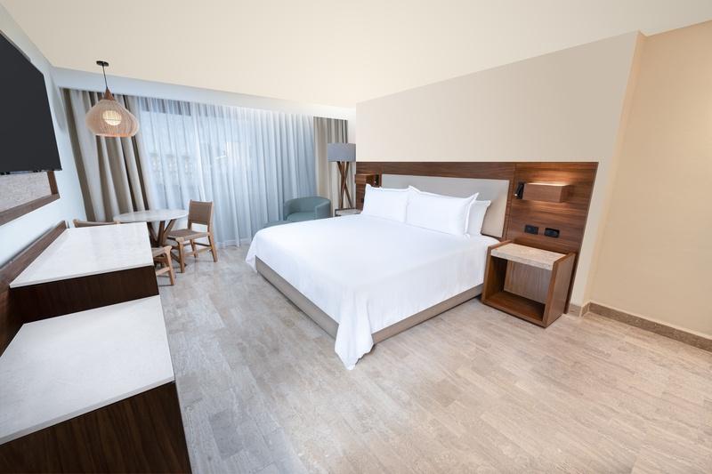 Standard Room with King Size bed decorated in gray, red, black and white in Oh! The Urban Oasis Hote